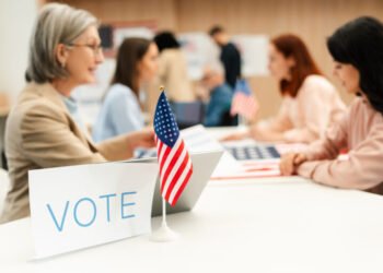 group of us citizens performing civic responsibility and voting at polling station