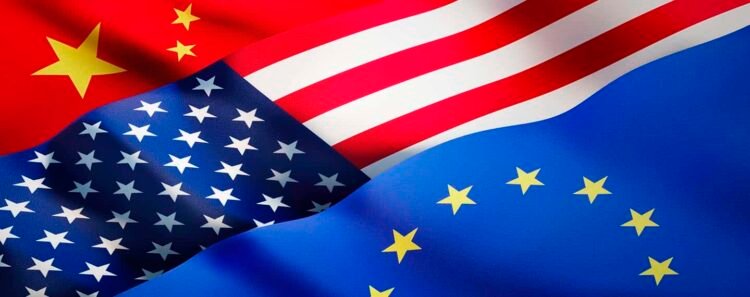 Banderas de China, EEUU y la UE ondeando. Foto: peterschreiber.media / Getty Images