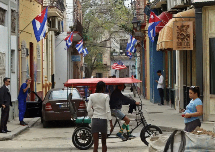 Personas transitan por una calle decorada con banderas de Cuba, en La Habana (Cuba). EFE/ Ernesto Mastrascusa.