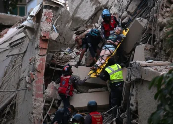Rescue workers carry a person on a stretcher out of a collapsed building following an earthquake in Caracas on June 24, 2026. Juan Barreto/Getty Images