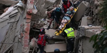 Rescue workers carry a person on a stretcher out of a collapsed building following an earthquake in Caracas on June 24, 2026. Juan Barreto/Getty Images