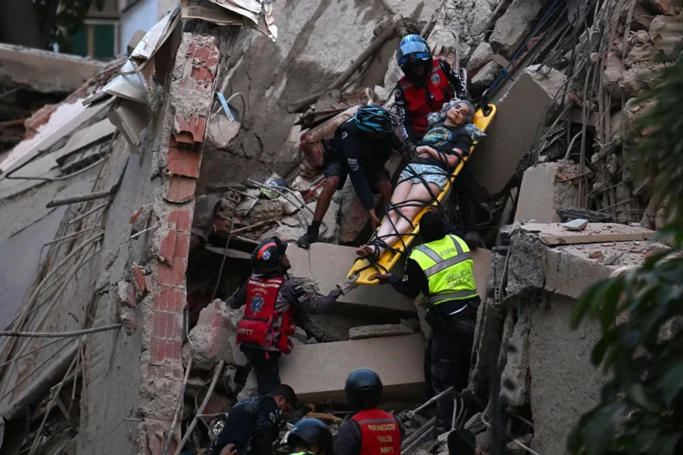 Rescue workers carry a person on a stretcher out of a collapsed building following an earthquake in Caracas on June 24, 2026. Juan Barreto/Getty Images